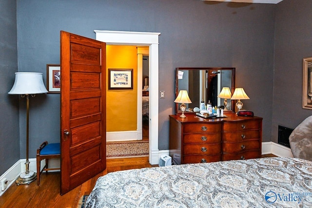 bedroom featuring baseboards and wood finished floors