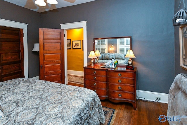 bedroom featuring baseboards and wood finished floors