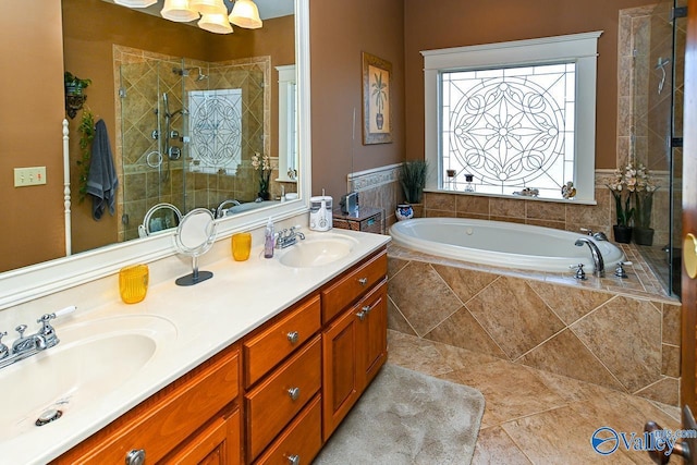 bathroom with a shower stall, a garden tub, double vanity, and a sink