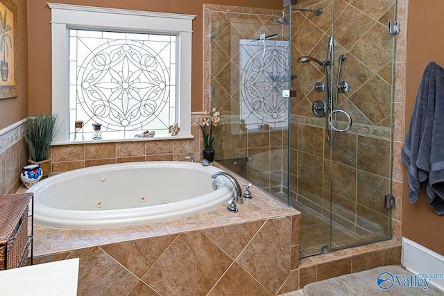 full bathroom with a shower stall and a tub with jets