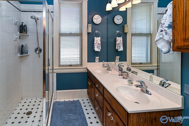 bathroom with a sink, double vanity, and a shower stall