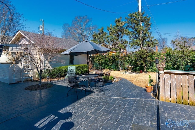 view of patio featuring fence