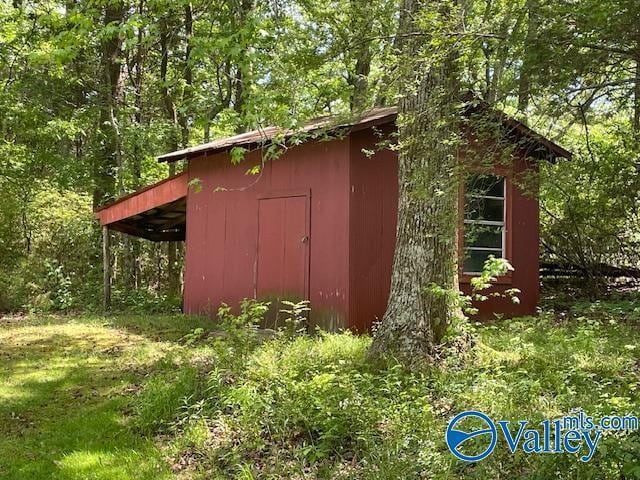 view of shed with a forest view