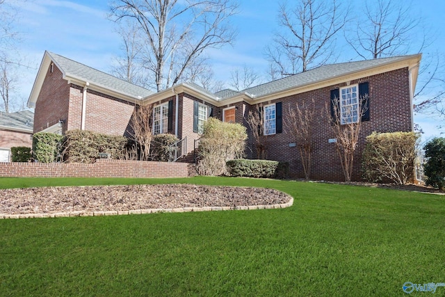 single story home with a front yard, brick siding, and fence