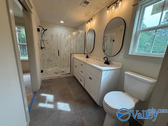 6255 Vista Trl, Southside, AL 35907 - bathroom with toilet, a textured ceiling, a marble finish shower, tile patterned flooring, and double vanity