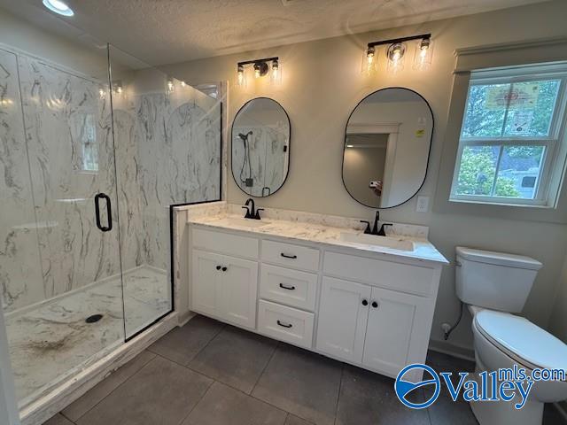 6255 Vista Trl, Southside, AL 35907 - bathroom with toilet, tile patterned flooring, a marble finish shower, double vanity, and a textured ceiling