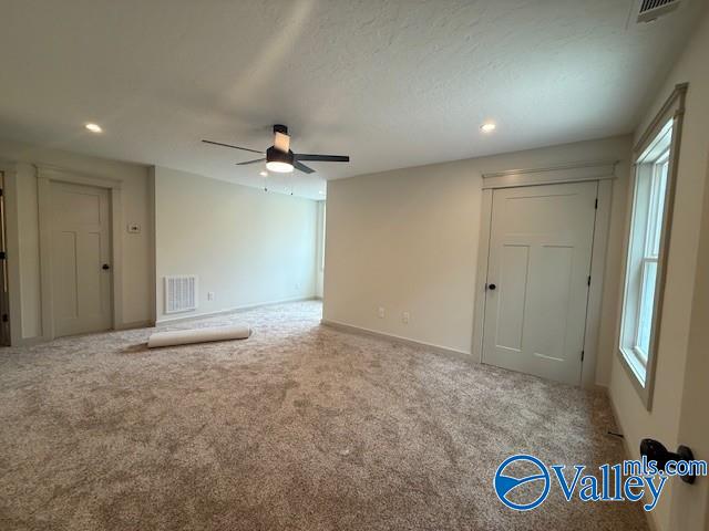 6255 Vista Trl, Southside, AL 35907 - unfurnished living room with carpet floors, a ceiling fan, plenty of natural light, and recessed lighting