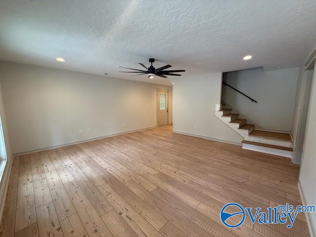 6255 Vista Trl, Southside, AL 35907 - unfurnished living room featuring a ceiling fan, light wood-style floors, stairway, baseboards, and recessed lighting