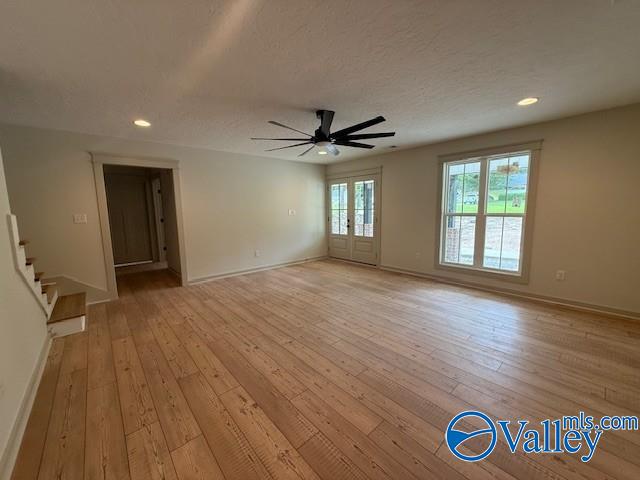 6255 Vista Trl, Southside, AL 35907 - unfurnished living room featuring ceiling fan, light wood-style flooring, baseboards, recessed lighting, and stairway