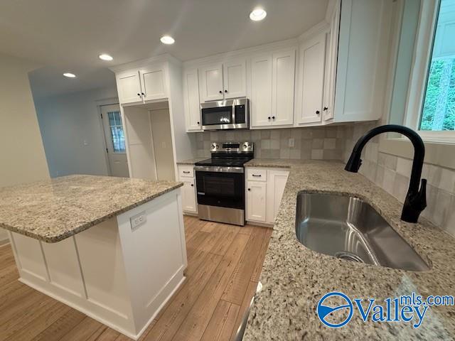 6255 Vista Trl, Southside, AL 35907 - kitchen with appliances with stainless steel finishes, a sink, light wood-style floors, white cabinetry, and recessed lighting