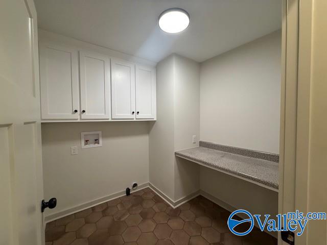 6255 Vista Trl, Southside, AL 35907 - clothes washing area with cabinet space, washer hookup, baseboards, and dark tile patterned floors