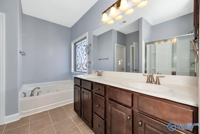 full bath with a sink, visible vents, a shower stall, and tile patterned floors