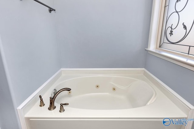 bathroom with a tub with jets