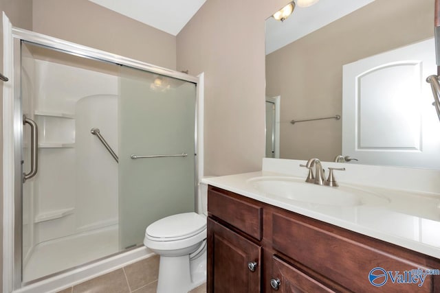bathroom with tile patterned flooring, a shower stall, toilet, and vanity