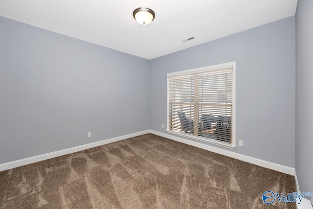 spare room with visible vents, carpet flooring, and baseboards