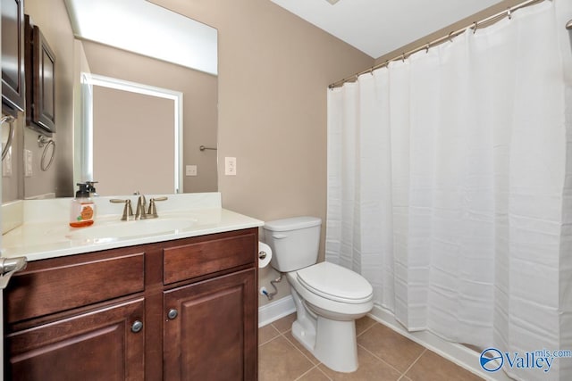bathroom with tile patterned floors, toilet, curtained shower, baseboards, and vanity