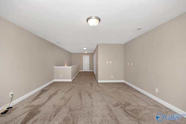 interior space featuring carpet flooring, visible vents, and baseboards