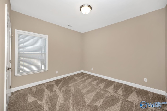 spare room with visible vents, baseboards, and carpet floors