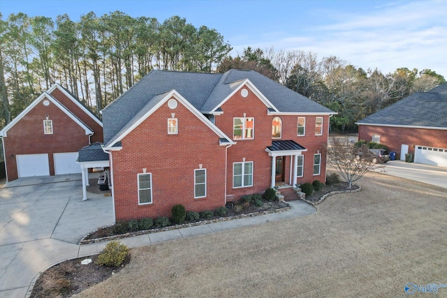 view of front of house with a garage, driveway, a shingled roof, and brick siding