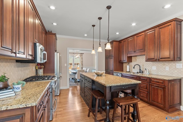 kitchen featuring a kitchen island, pendant lighting, stainless steel appliances, and light stone counters