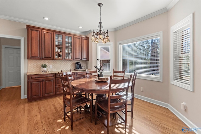 dining room featuring baseboards, ornamental molding, recessed lighting, and light wood-style floors