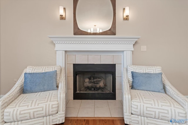 room details with wood finished floors and a tile fireplace