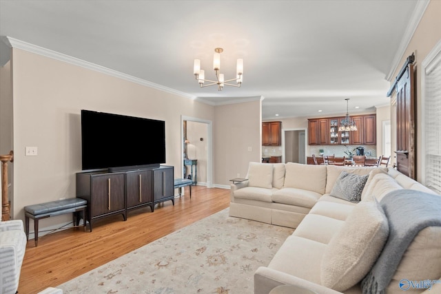 living area with baseboards, ornamental molding, light wood-style flooring, and a notable chandelier