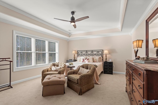 bedroom featuring light carpet, a tray ceiling, and crown molding