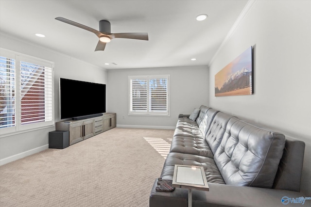 living room with light carpet, baseboards, ornamental molding, and ceiling fan