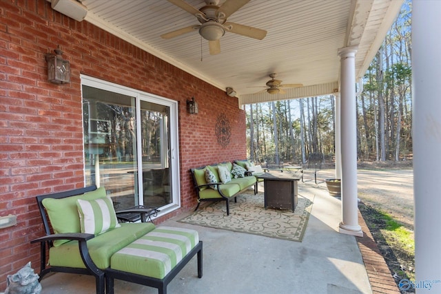 view of patio with ceiling fan and an outdoor living space with a fire pit