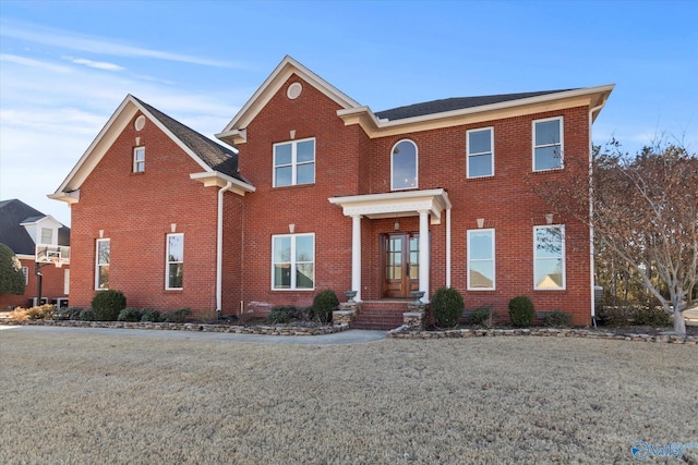 view of front of property with a front yard and brick siding