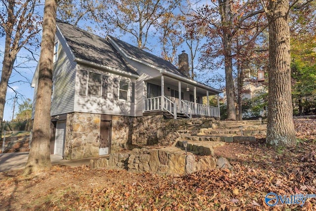 exterior space featuring covered porch and a garage