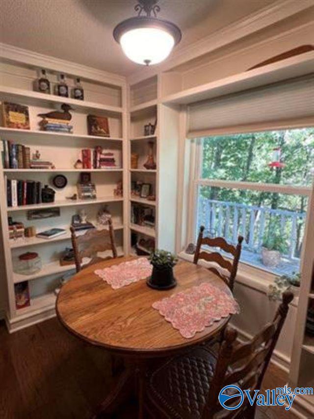 dining room featuring ornamental molding and wood finished floors