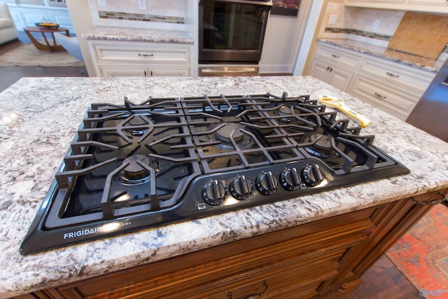 details with stainless steel oven and gas cooktop