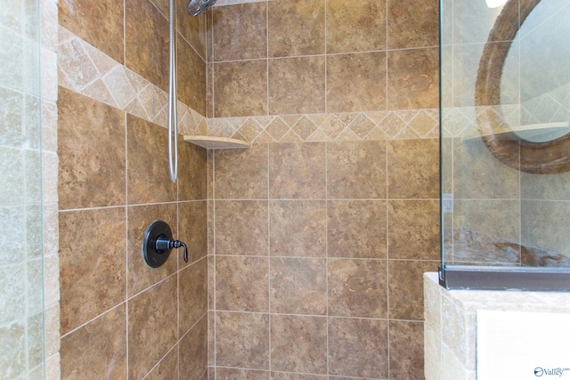 bathroom with a tile shower