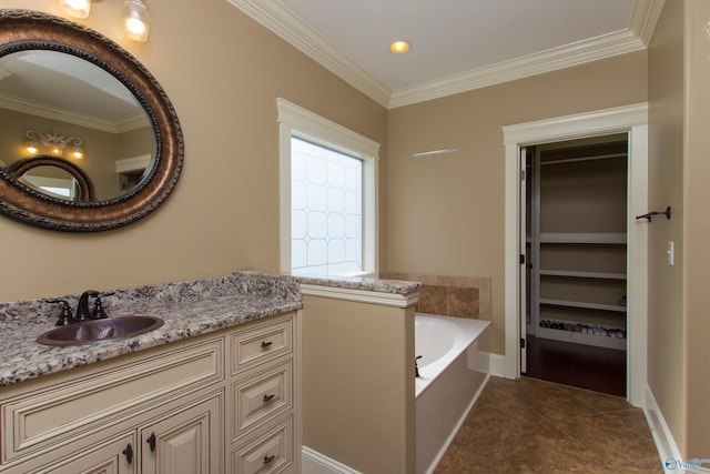 bathroom with a bath, tile patterned floors, vanity, and ornamental molding