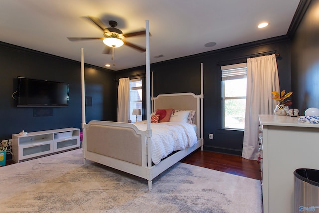 bedroom featuring hardwood / wood-style flooring, ceiling fan, and crown molding