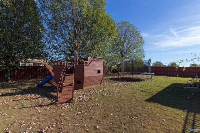 view of yard featuring a playground and a trampoline