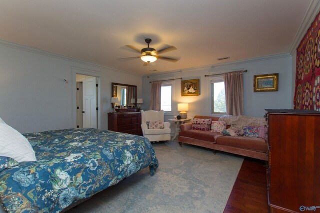 bedroom with dark hardwood / wood-style floors, ceiling fan, and crown molding