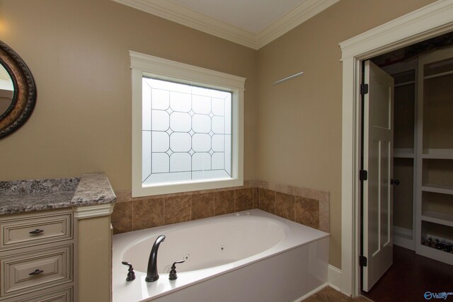 bathroom with a bathing tub and crown molding