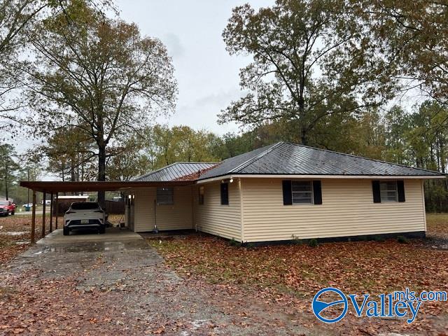 view of property exterior featuring a carport