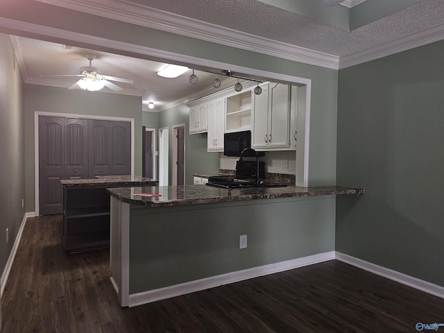 kitchen with white cabinets, a peninsula, a sink, open shelves, and black appliances