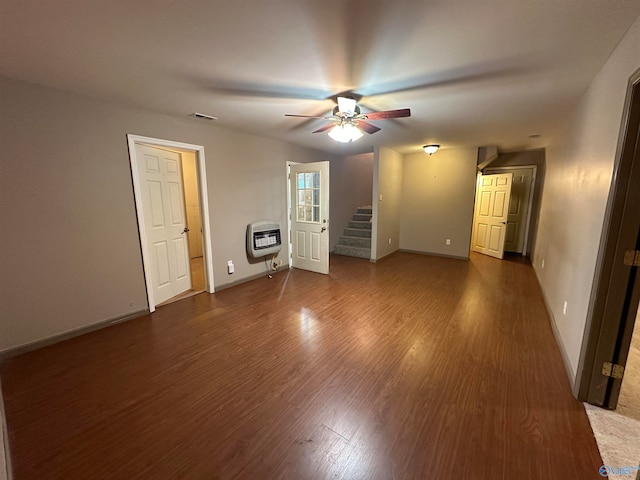 unfurnished bedroom with dark hardwood / wood-style floors, ceiling fan, and heating unit