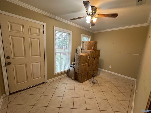 tiled foyer entrance featuring ceiling fan and ornamental molding