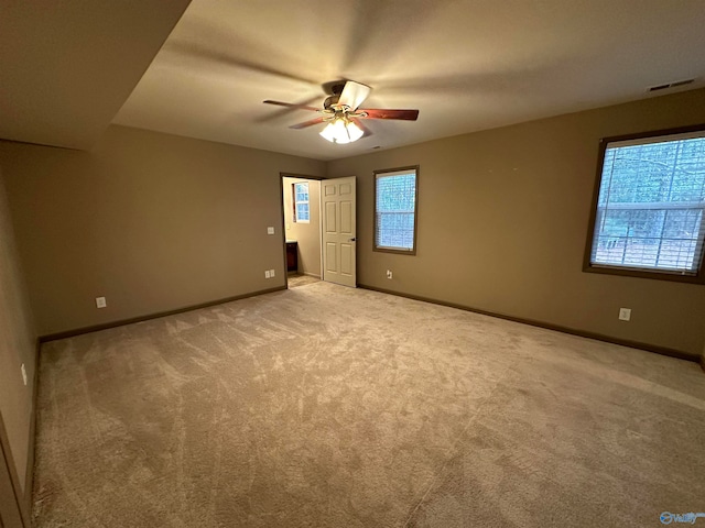 unfurnished room with ceiling fan and light colored carpet