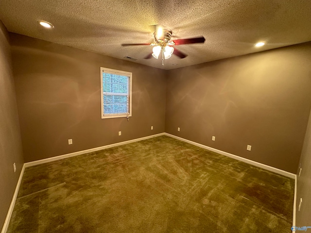 carpeted empty room featuring ceiling fan and a textured ceiling