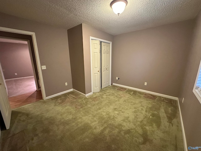 unfurnished bedroom featuring a closet, carpet floors, and a textured ceiling
