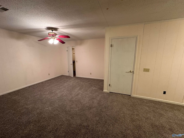 carpeted spare room with a textured ceiling and ceiling fan