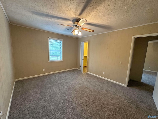unfurnished bedroom featuring ceiling fan, crown molding, dark carpet, and a textured ceiling