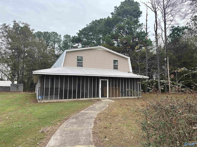view of front of home featuring a sunroom and a front yard
